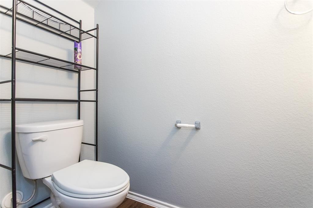 2103 Meadow Park Drive Princeton, TX 75407 - Photo 20 of 30 a white toilet sitting next to a shower