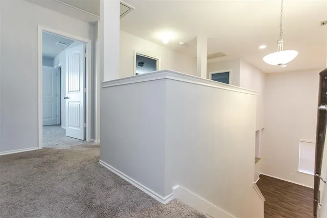 an empty room with windows and entrance to other room