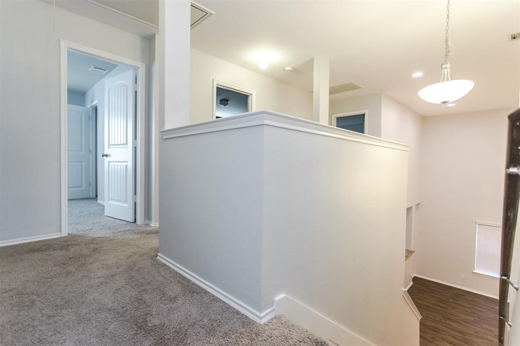 2103 Meadow Park Drive Princeton, TX 75407 - Photo 24 of 30 a view of a hallway with wooden floor