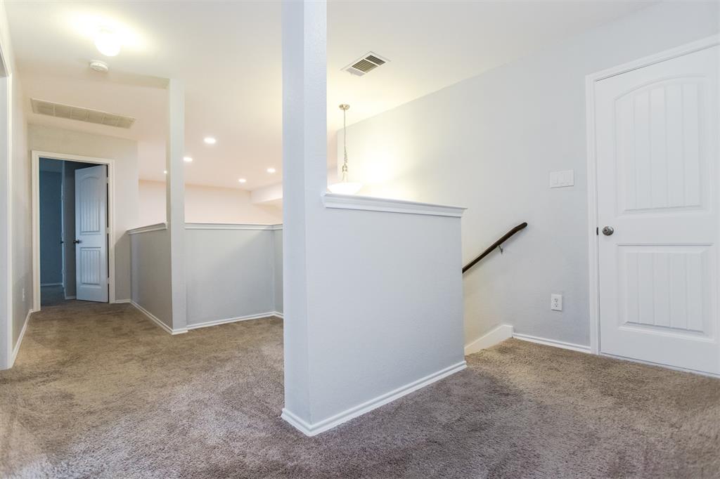 2103 Meadow Park Drive Princeton, TX 75407 - Photo 25 of 30 an empty room with windows and entrance to other room