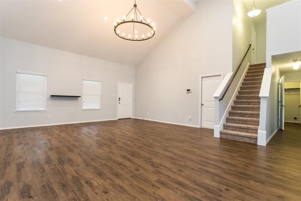 2103 Meadow Park Drive Princeton, TX 75407 - Photo 7 of 30 a view of an empty room with wooden floor and stairs
