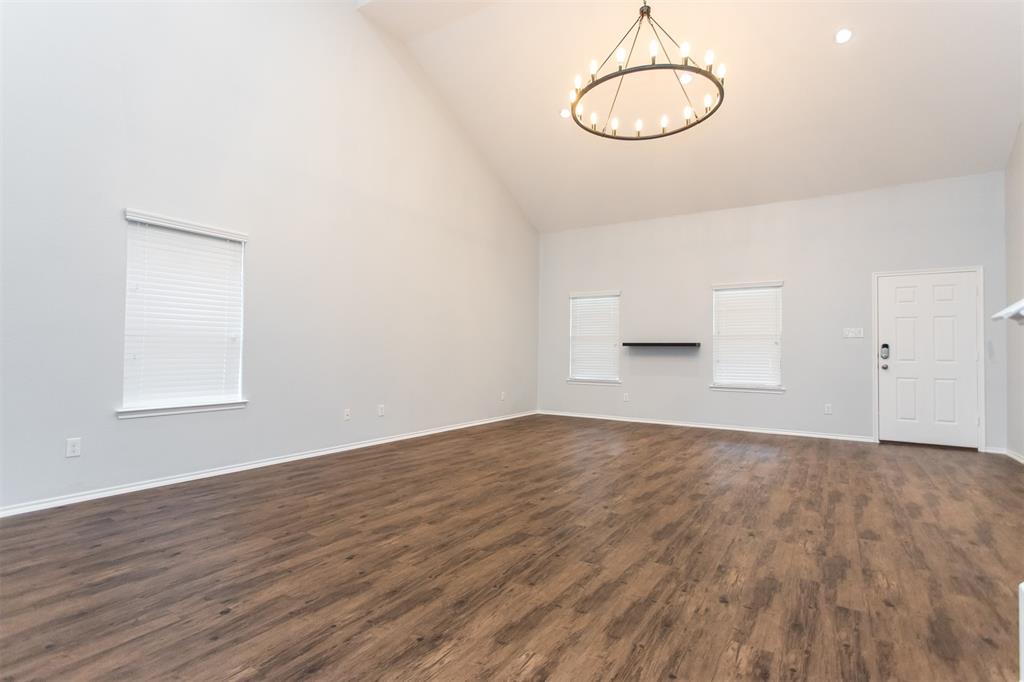 2103 Meadow Park Drive Princeton, TX 75407 - Photo 8 of 30 a view of empty room with wooden floor and window