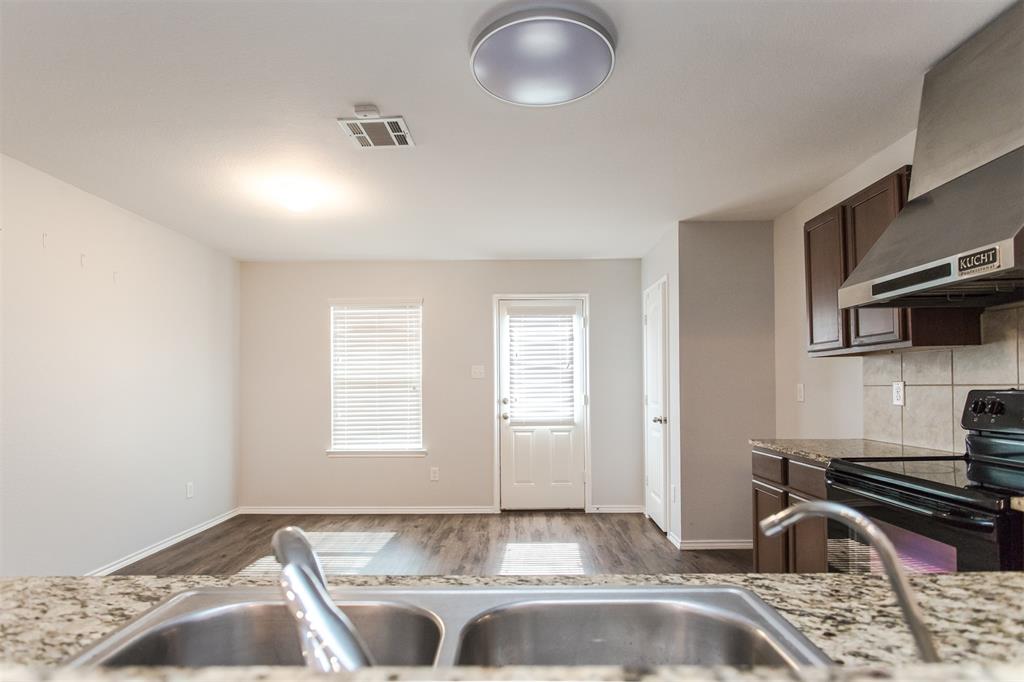 2103 Meadow Park Drive Princeton, TX 75407 - Photo 10 of 30 a kitchen with granite countertop a sink stainless steel appliances and cabinets