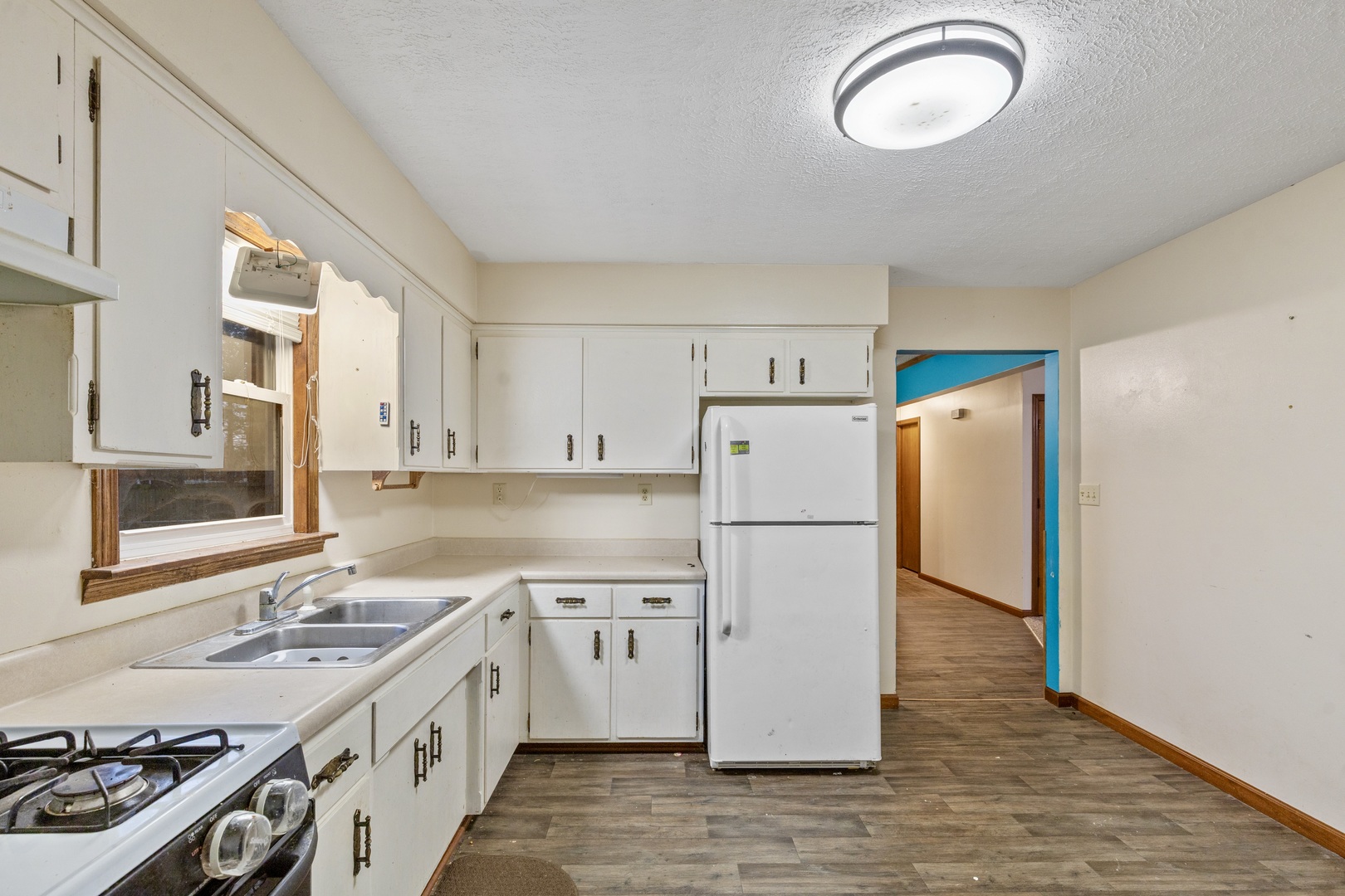 209 West Indiana Street Momence, IL 60954 - Photo 14 of 34 a kitchen with a white stove top oven and refrigerator