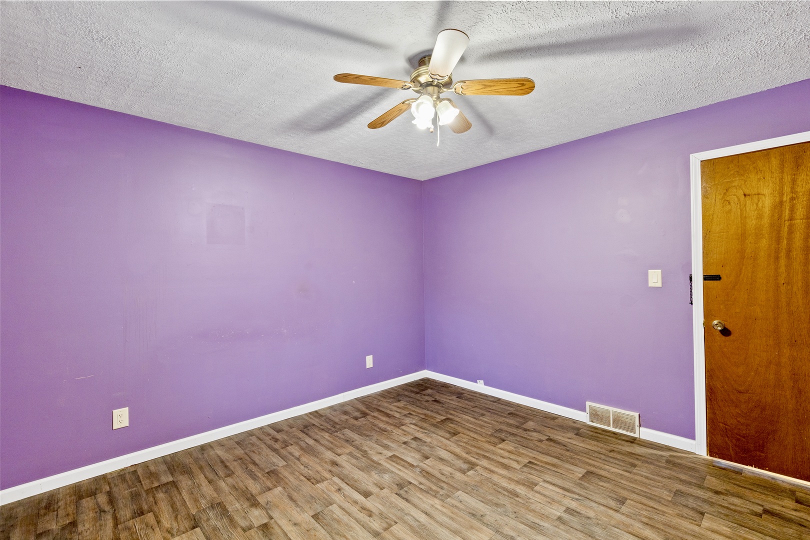 209 West Indiana Street Momence, IL 60954 - Photo 22 of 34 a view of an empty room with chandelier fan and a wooden floor