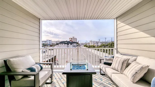 a view of a balcony with furniture and a floor to ceiling window