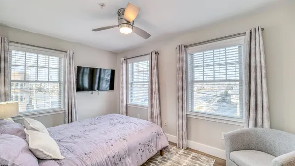 a bedroom with a large bed and a window