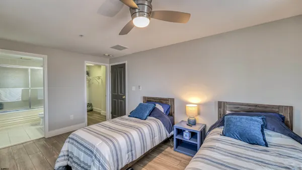 a bedroom with bed and wooden floor