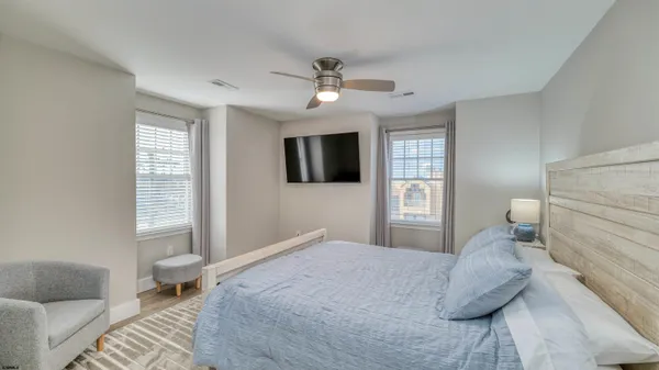 a bedroom with a large bed and a couch
