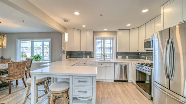 a kitchen with a table chairs refrigerator and cabinets