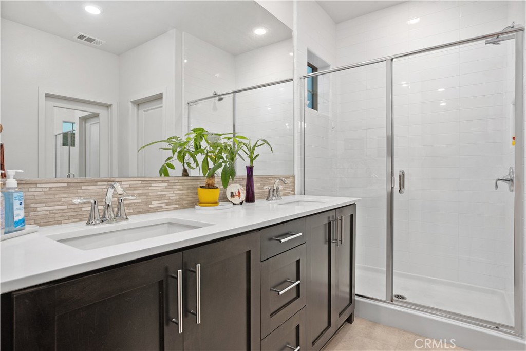 4366 Pacifica Way, Unit 7 Oceanside, CA 92056 - Photo 18 of 36 a bathroom with a double vanity sink and a mirror