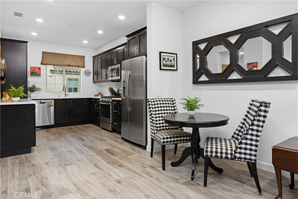 4366 Pacifica Way, Unit 7 Oceanside, CA 92056 - Photo 2 of 36 a kitchen with stainless steel appliances kitchen island granite countertop a sink and cabinets