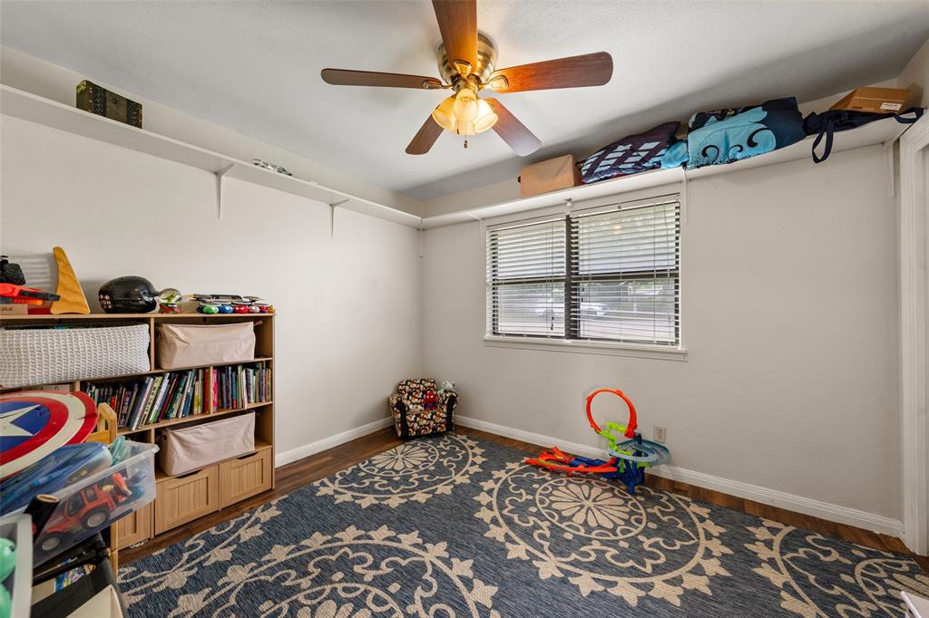 608 West Spring Street West, TX 76691 - Photo 11 of 27 a bedroom with furniture and a book shelf