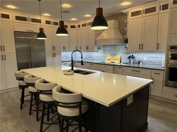 a kitchen with a table chairs and a refrigerator