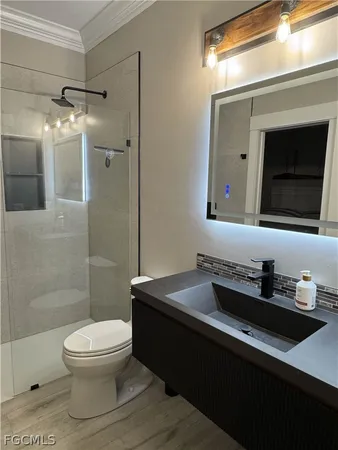 a bathroom with a sink toilet and shower
