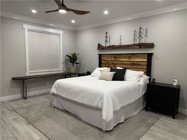 a bedroom with a bed and a potted plant