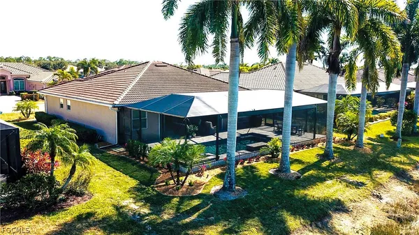 a view of a house with swimming pool and sitting area