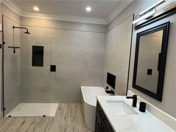 a bathroom with a sink a mirror and shower
