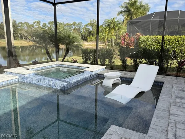 a view of swimming pool with a lounge chairs