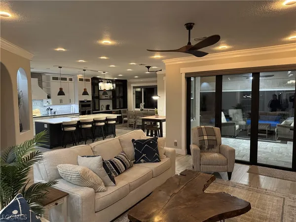 a living room with furniture and kitchen view