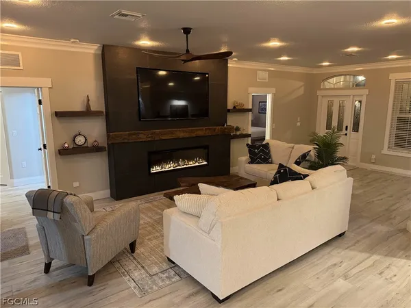 a living room with furniture and a fireplace