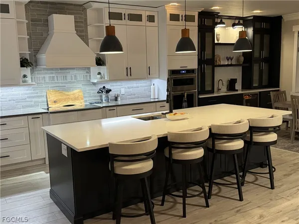 a kitchen with a kitchen island a stove and a dining table