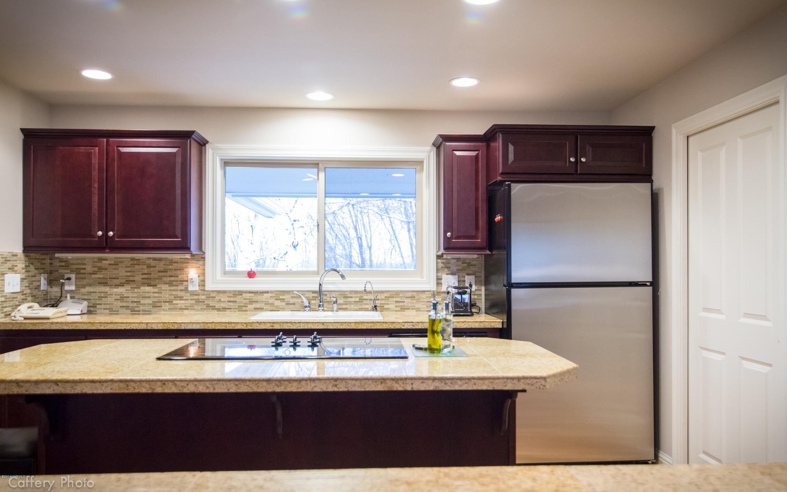 1271 Lateral B Road Wapato, WA 98951 - Photo 12 of 32 a kitchen with kitchen island a sink a stove and a refrigerator