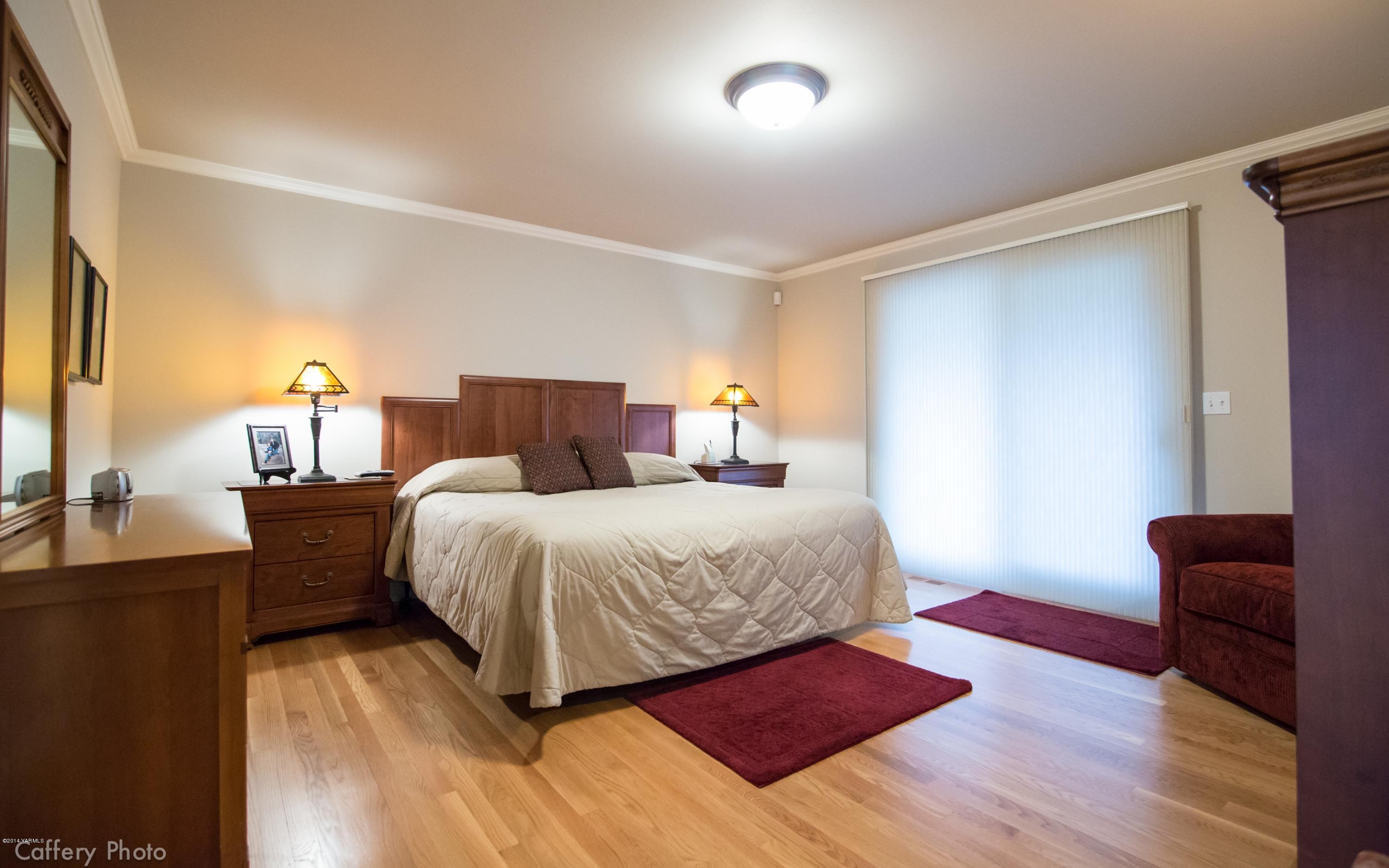 1271 Lateral B Road Wapato, WA 98951 - Photo 15 of 32 a bedroom with a bed and wooden floor
