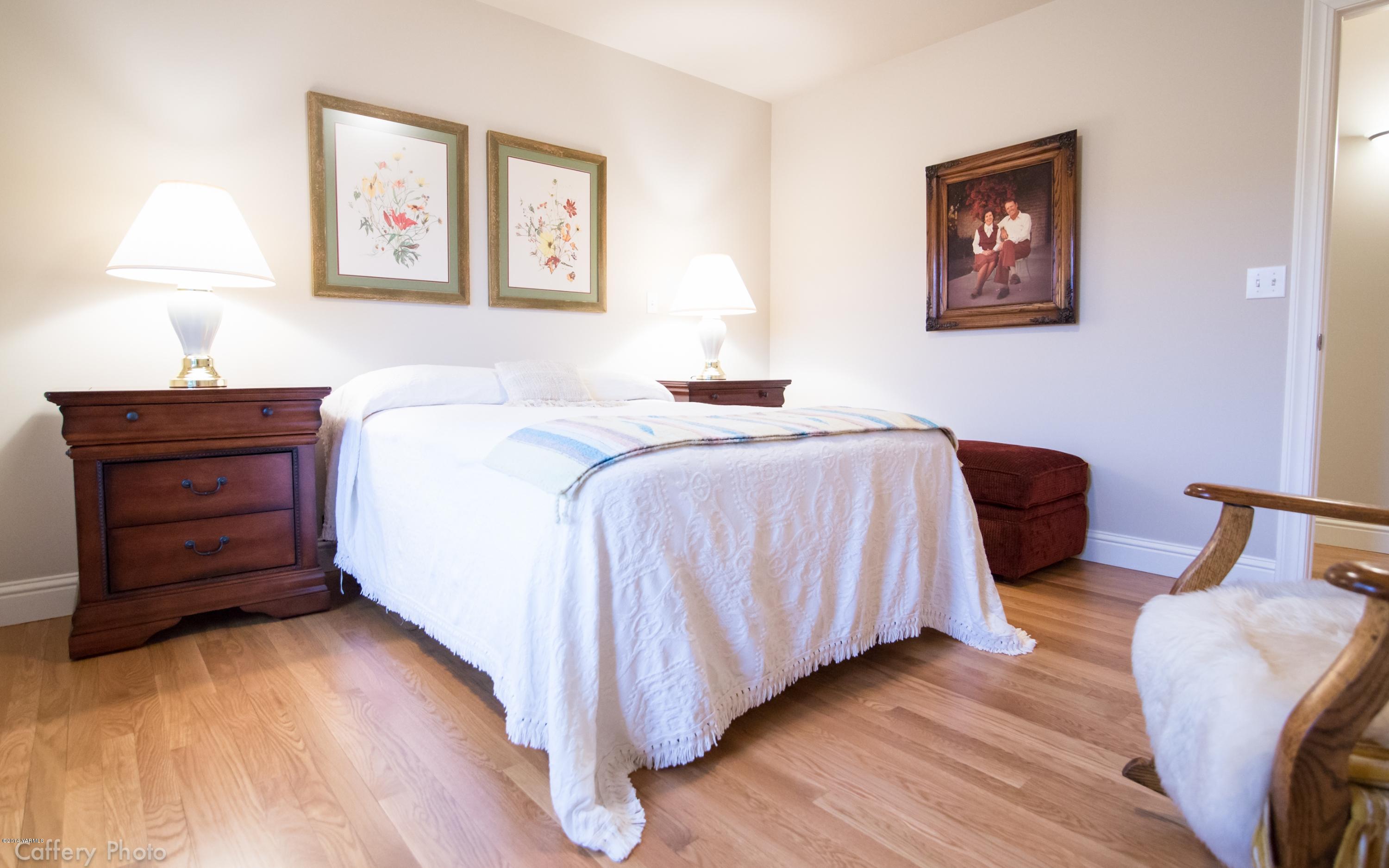 1271 Lateral B Road Wapato, WA 98951 - Photo 20 of 32 a bedroom with a bed and a lamp on dresser