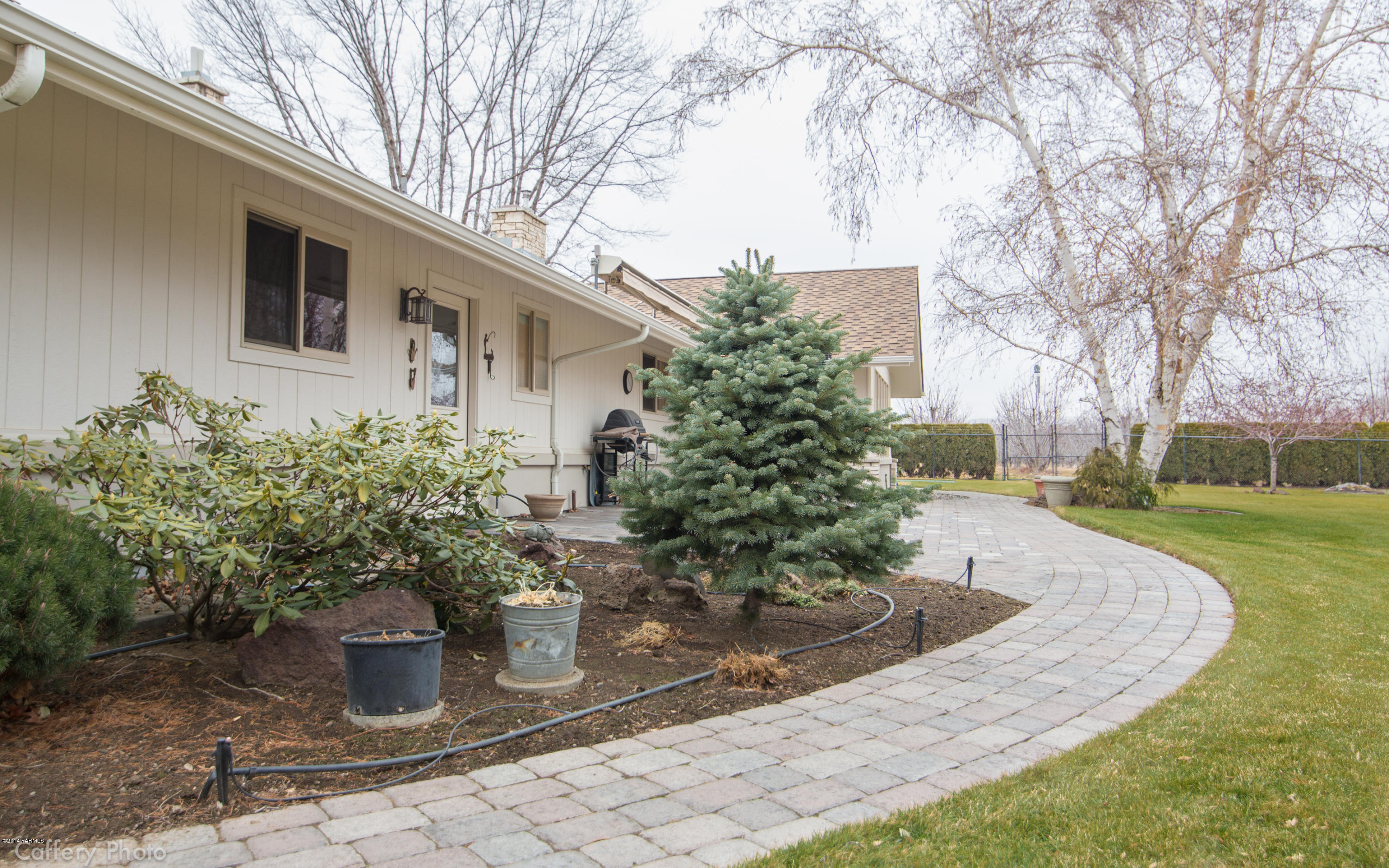 1271 Lateral B Road Wapato, WA 98951 - Photo 23 of 32 a view of a backyard with potted plants and large trees