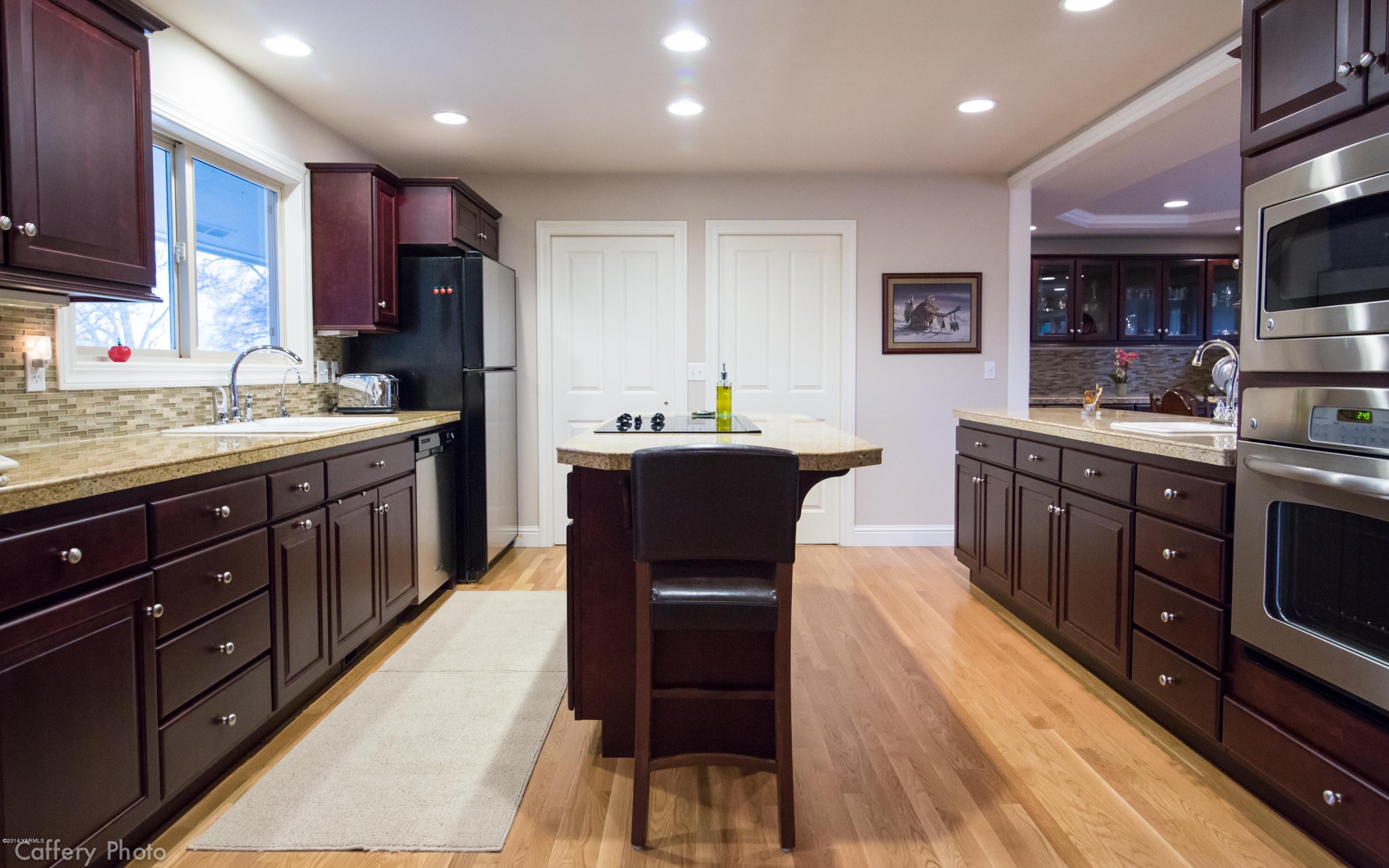 1271 Lateral B Road Wapato, WA 98951 - Photo 10 of 32 a kitchen with stainless steel appliances kitchen island granite countertop a sink counter space and cabinets