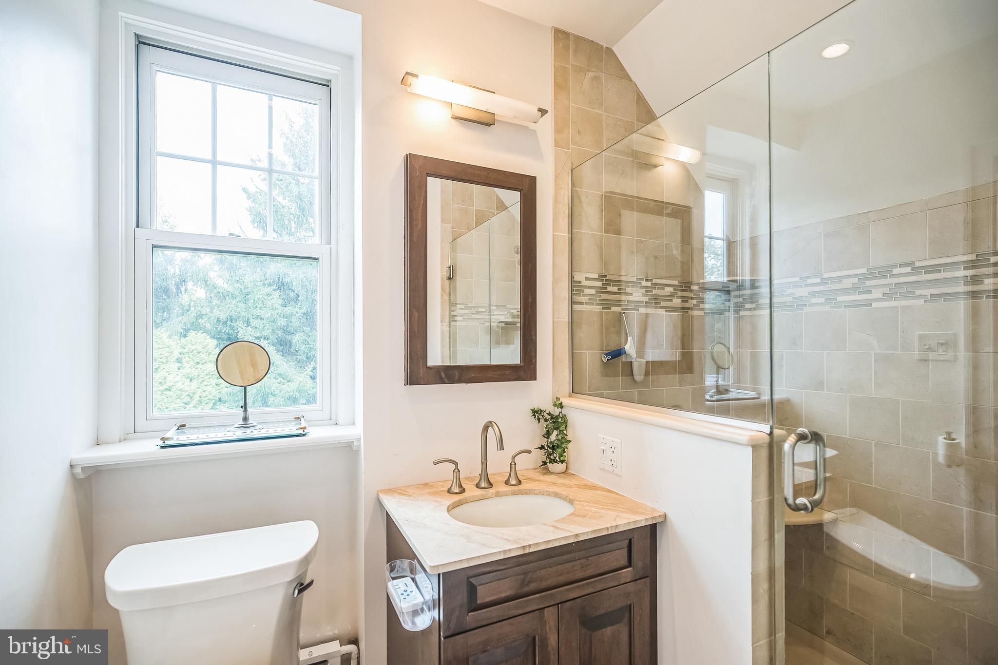 102 Maple Avenue Wyncote, PA 19095 - Photo 14 of 30 a bathroom with a toilet a sink a mirror and a shower