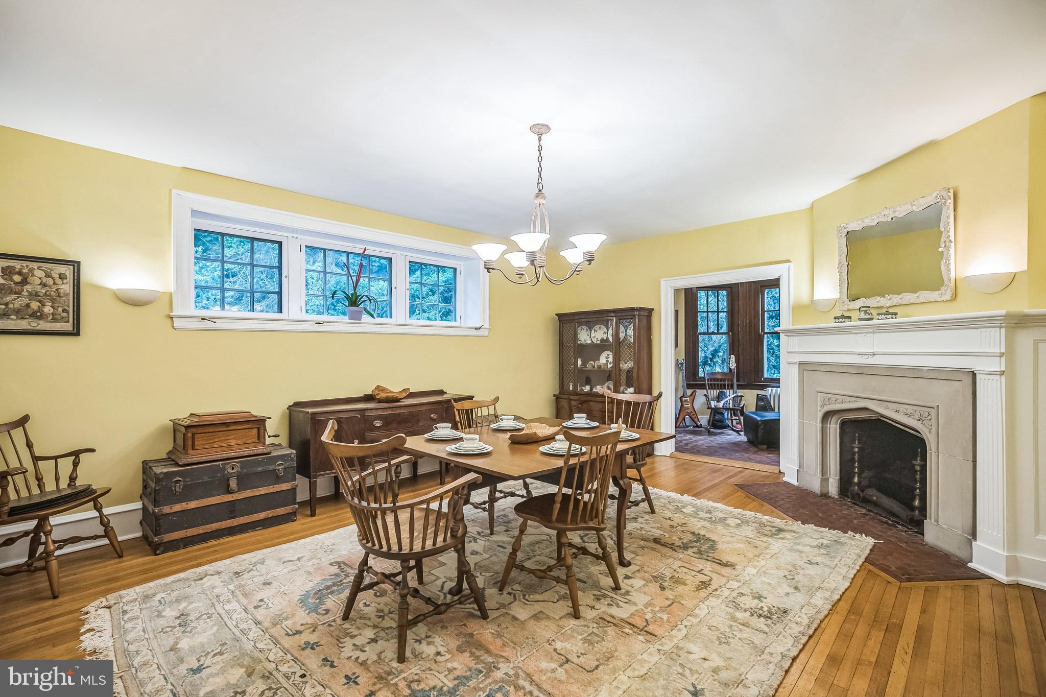 102 Maple Avenue Wyncote, PA 19095 - Photo 6 of 30 a dining room with furniture a fireplace and wooden floor