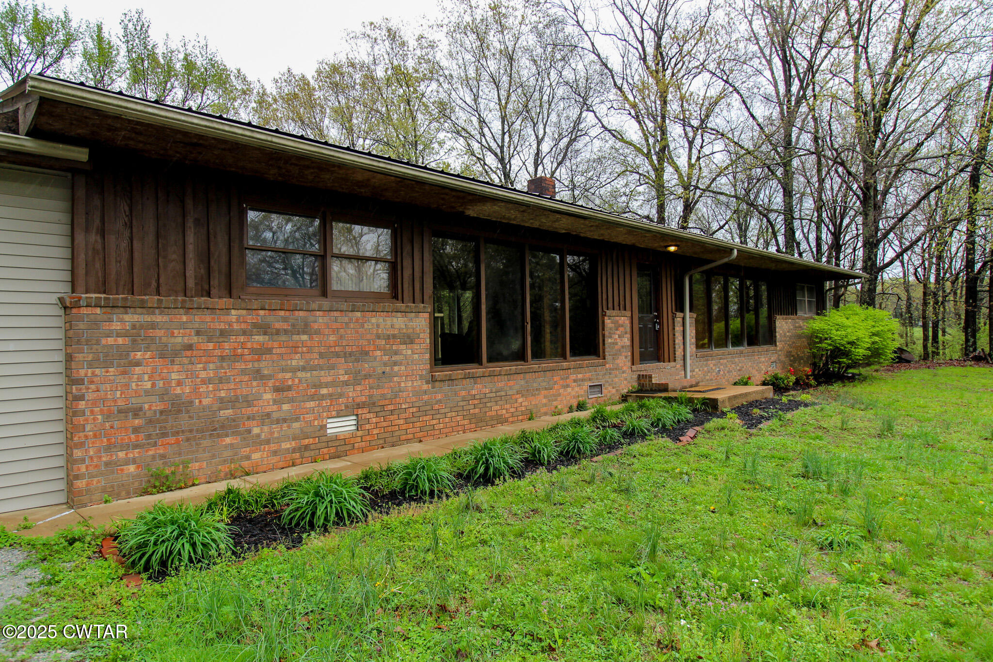 326 Fancy Road Dresden, TN 38225 - Photo 2 of 45 a view of a backyard with potted plants and large tree