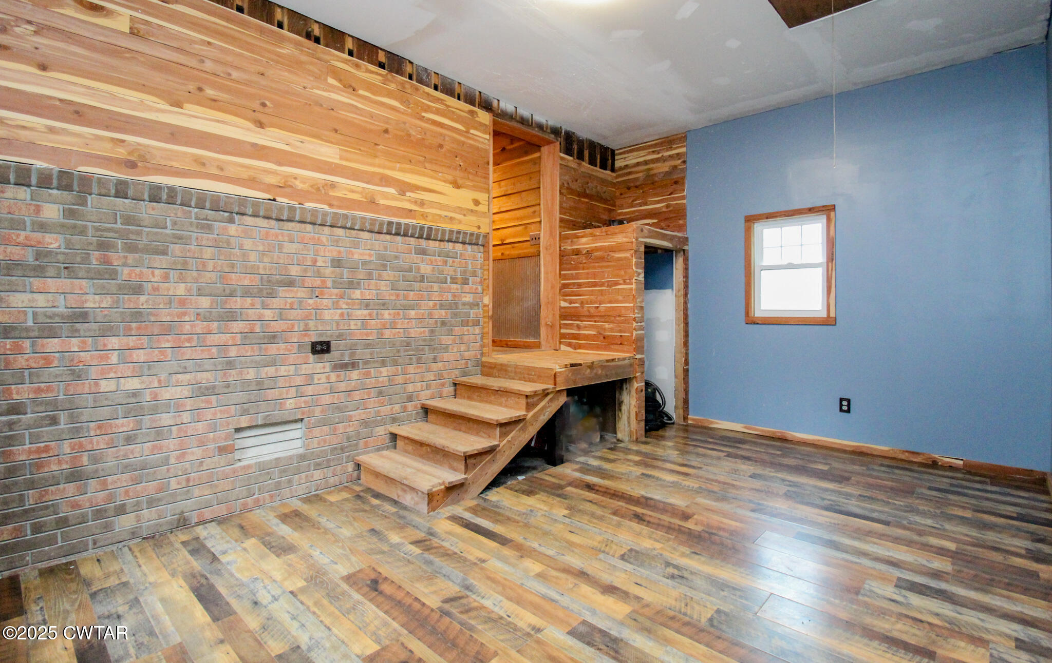 326 Fancy Road Dresden, TN 38225 - Photo 33 of 45 a view of an empty room with stairs and wooden floor