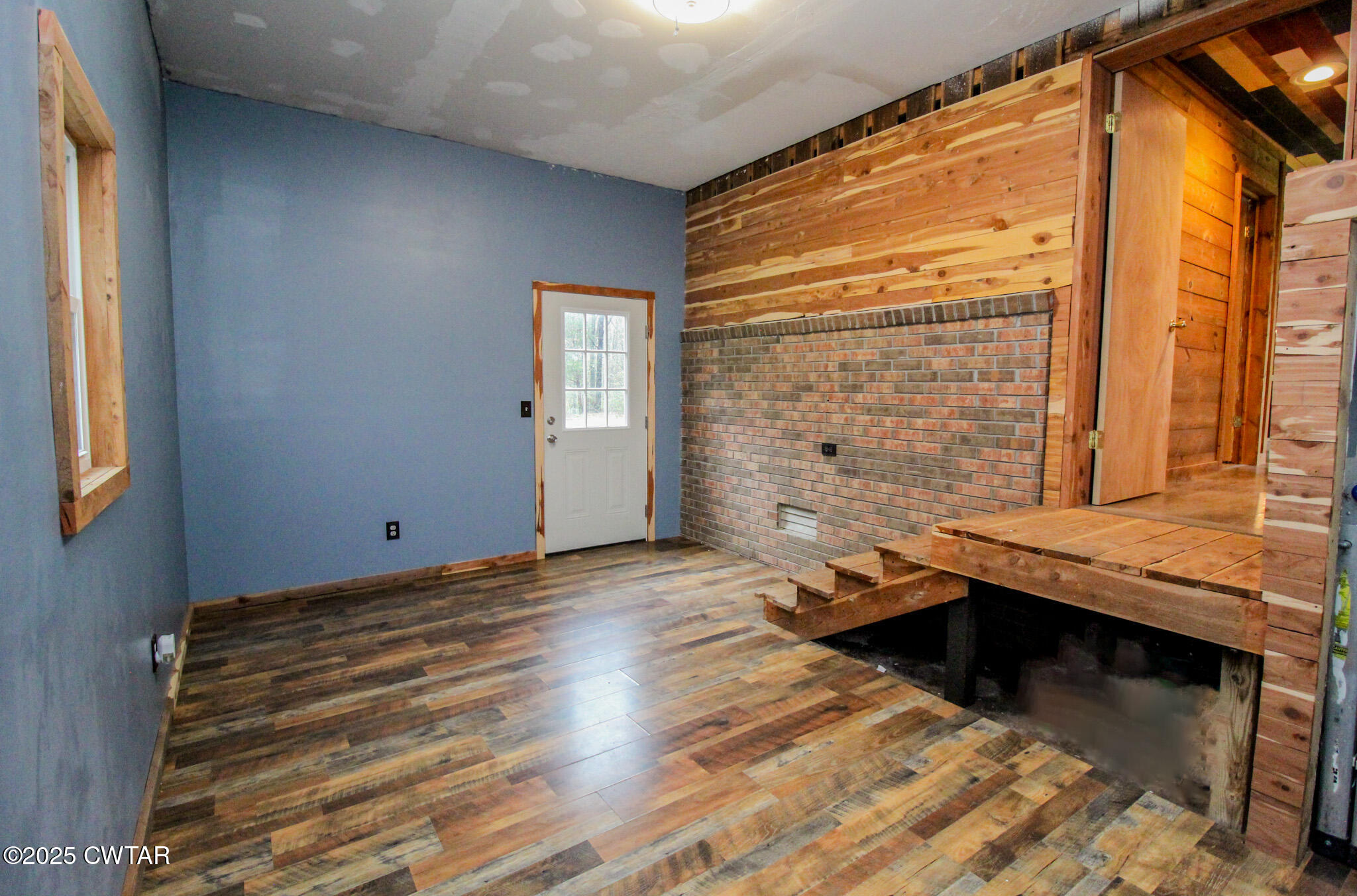 326 Fancy Road Dresden, TN 38225 - Photo 34 of 45 a view of a bedroom with a window and wooden floor