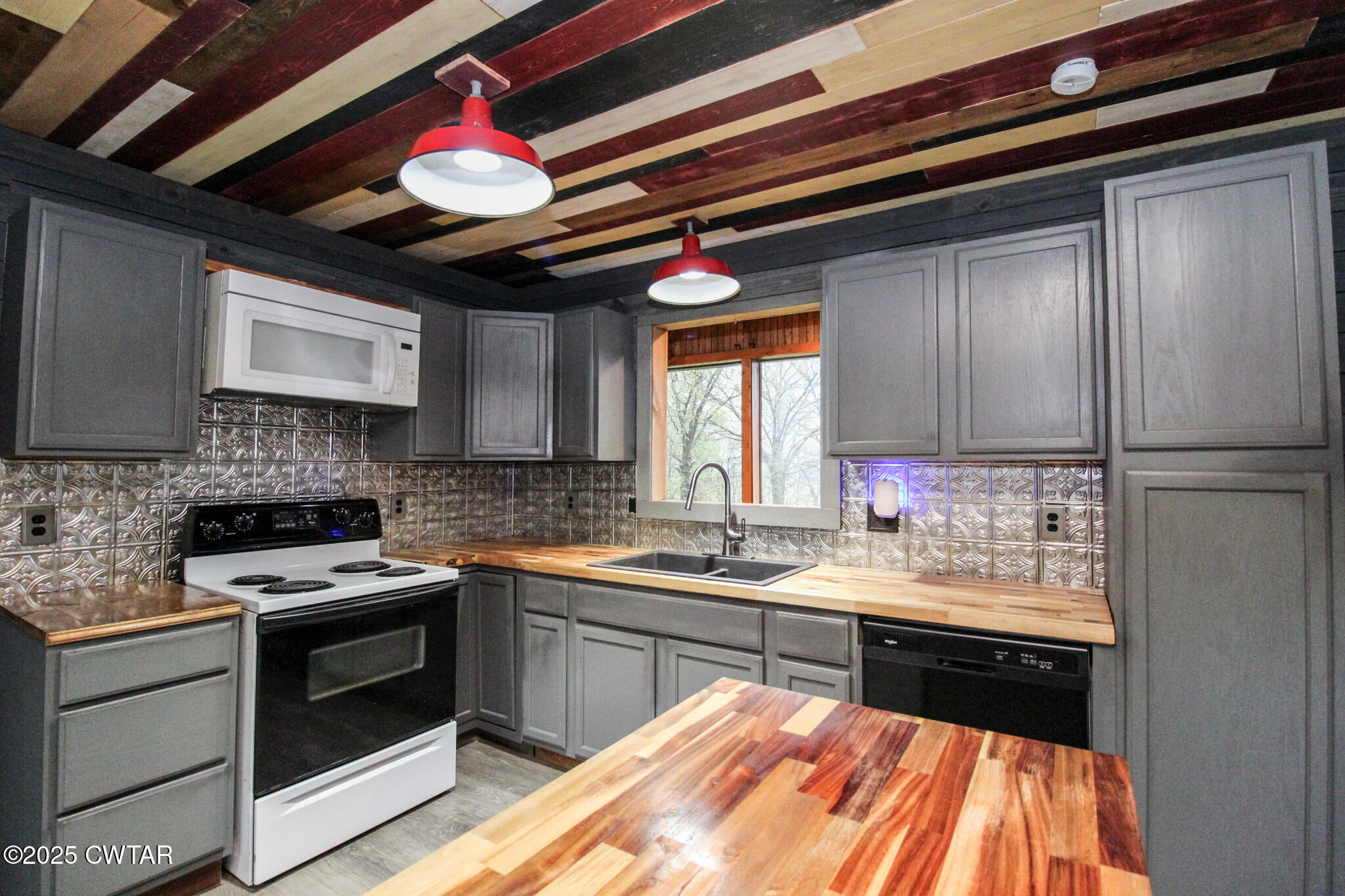 326 Fancy Road Dresden, TN 38225 - Photo 6 of 45 a kitchen with a stove sink and cabinets