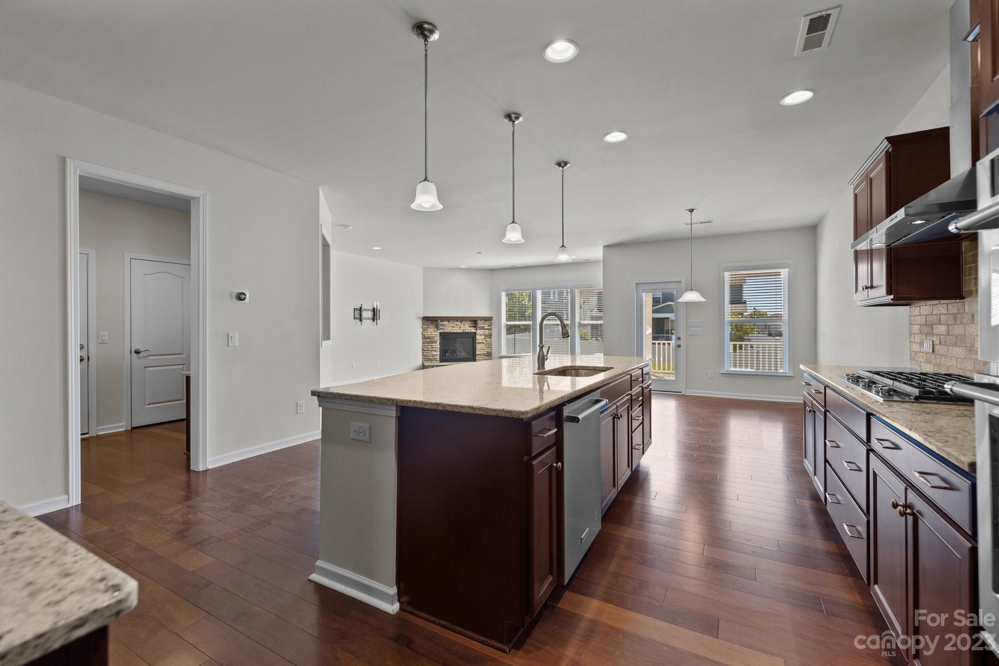2017 Sugaree Commons Fort Mill, SC 29715 - Photo 18 of 48 a kitchen with stainless steel appliances granite countertop a stove a sink a refrigerator and a wooden floor