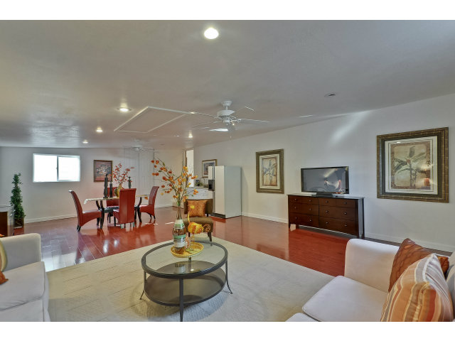 21841 McClellan Road Cupertino, CA 95014 - Photo 18 of 25 a living room with furniture kitchen view and a wooden floor
