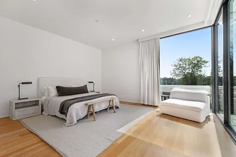 a spacious bedroom with a bed and a couch