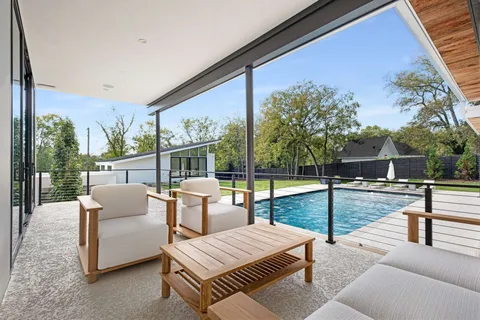 a balcony with furniture and a garden