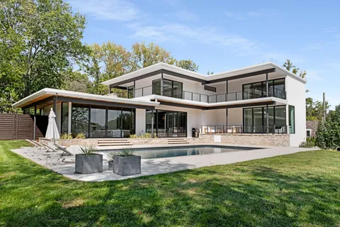 a front view of a house with a yard table and chairs