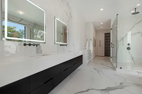 a spacious bathroom with a shower sink and mirror