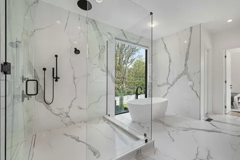 a bathroom with a bathtub and a shower