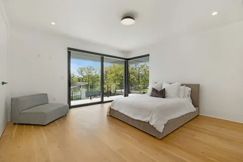 a large bedroom with a bed and a couch