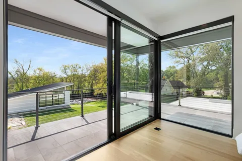 a view of a building with a floor to ceiling window with an outdoor view