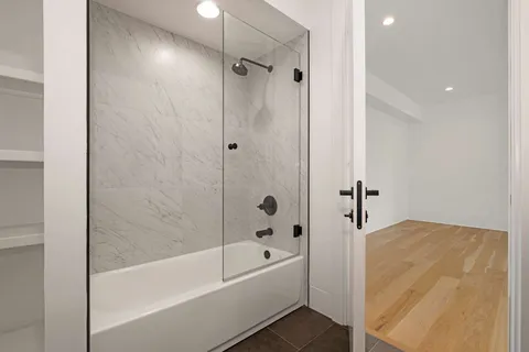 a bathroom with a bathtub and a shower