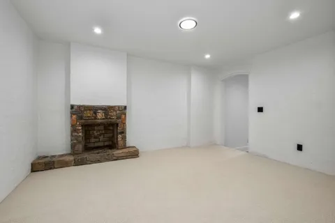 a view of an empty room with a fireplace