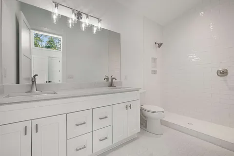 a bathroom with a toilet sink and mirror