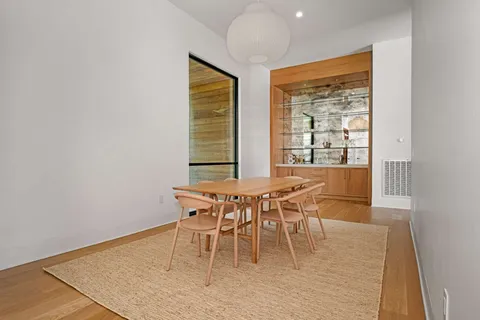 a dining room with furniture and wooden floor